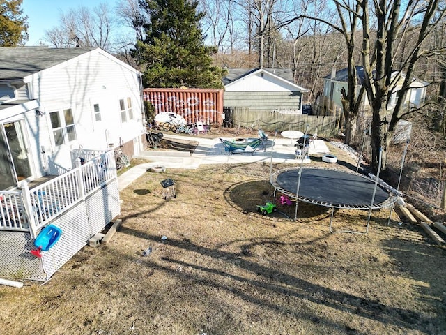 view of yard with a patio, a trampoline, and fence