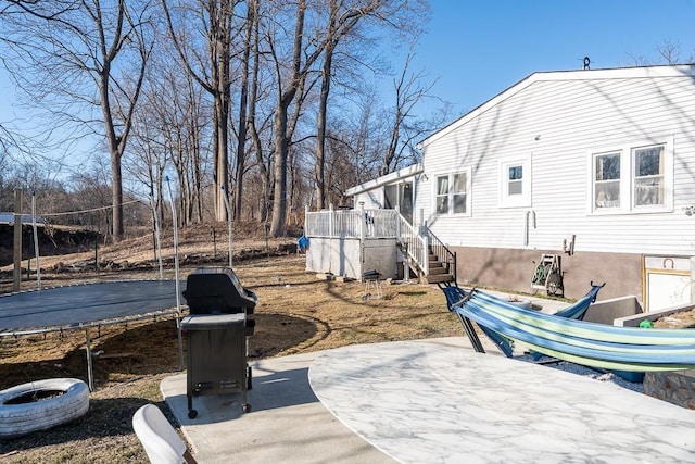 view of patio with stairway and a trampoline