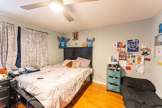 bedroom featuring baseboards, ceiling fan, and wood finished floors