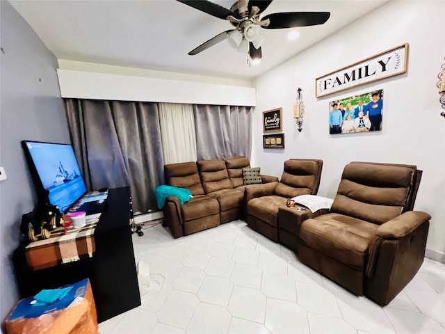 living room featuring baseboard heating and a ceiling fan