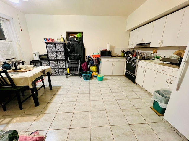 kitchen with under cabinet range hood, light countertops, light tile patterned floors, black electric range oven, and white cabinetry