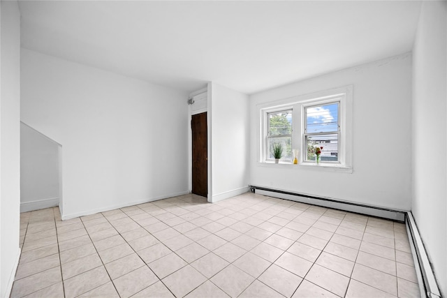 112-21 15th Ave, College Point, NY 11356 - empty room with baseboard heating, light tile patterned floors, and baseboards