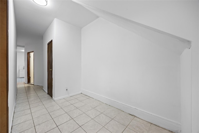 112-21 15th Ave, College Point, NY 11356 - additional living space with light tile patterned flooring, vaulted ceiling, and baseboards