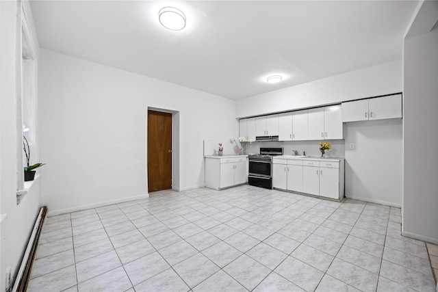 112-21 15th Ave, College Point, NY 11356 - kitchen featuring gas stove, a baseboard radiator, light countertops, and white cabinets