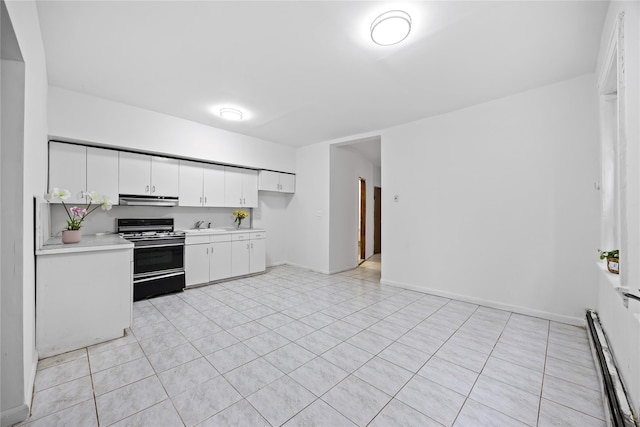 112-21 15th Ave, College Point, NY 11356 - kitchen with gas stove, extractor fan, a baseboard heating unit, light countertops, and white cabinetry