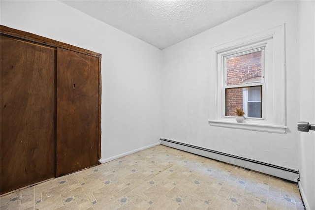 112-21 15th Ave, College Point, NY 11356 - unfurnished bedroom with a baseboard heating unit, a textured ceiling, and baseboards