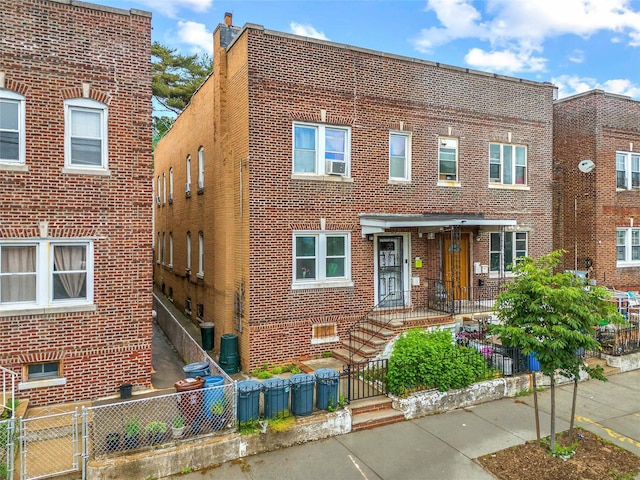 112-21 15th Ave, College Point, NY 11356 - multi unit property featuring brick siding, a fenced front yard, and a gate
