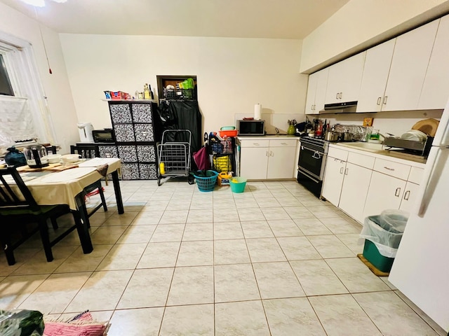112-21 15th Ave, College Point, NY 11356 - kitchen featuring black / electric stove, under cabinet range hood, light countertops, light tile patterned floors, and white cabinets