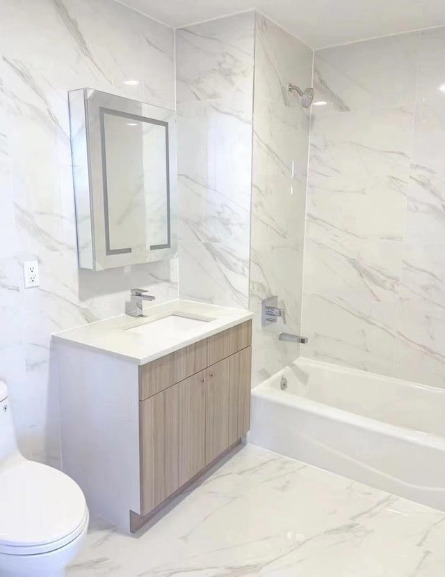 full bath featuring vanity, toilet, marble finish floor, and shower / bathtub combination