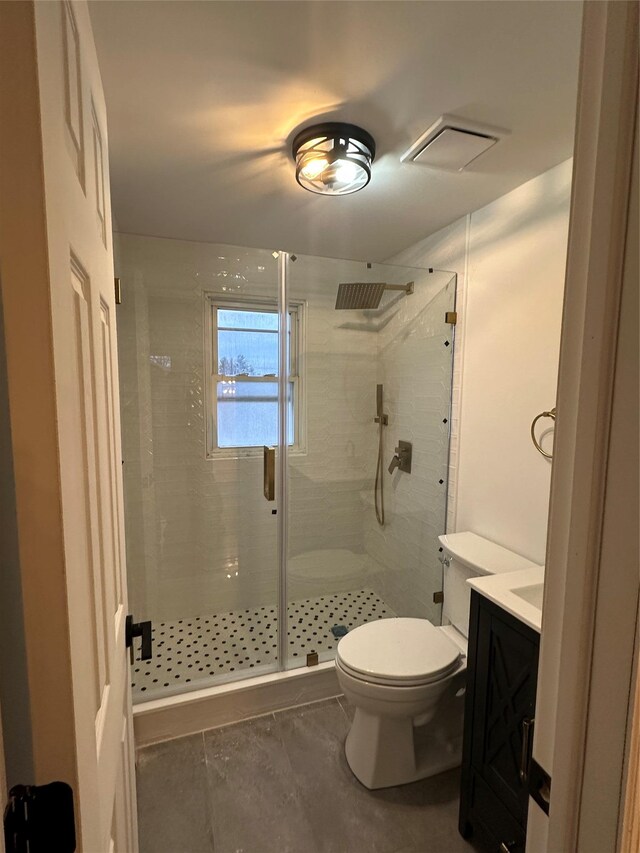 bathroom featuring visible vents, a stall shower, toilet, and vanity