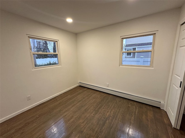 unfurnished bedroom featuring dark wood finished floors, recessed lighting, a baseboard heating unit, and baseboards