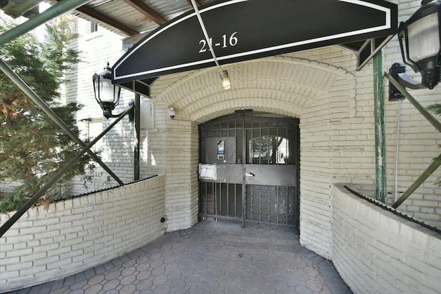 entrance to property featuring brick siding