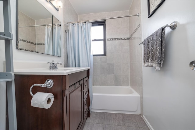 full bathroom with tile patterned flooring, shower / bath combination with curtain, vanity, and baseboards