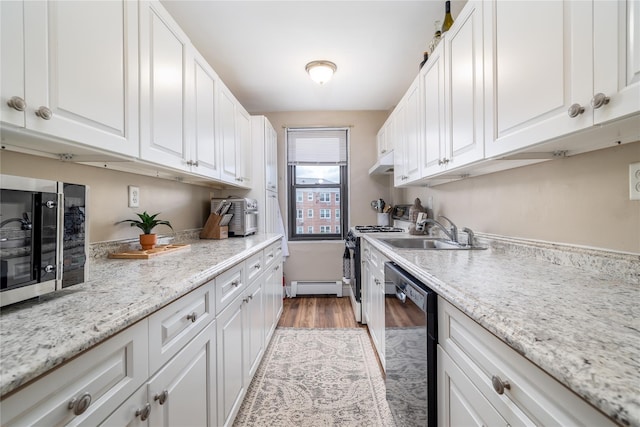 kitchen with a baseboard heating unit, under cabinet range hood, black dishwasher, range with gas stovetop, and a sink