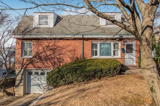 view of side of home with an attached garage and brick siding