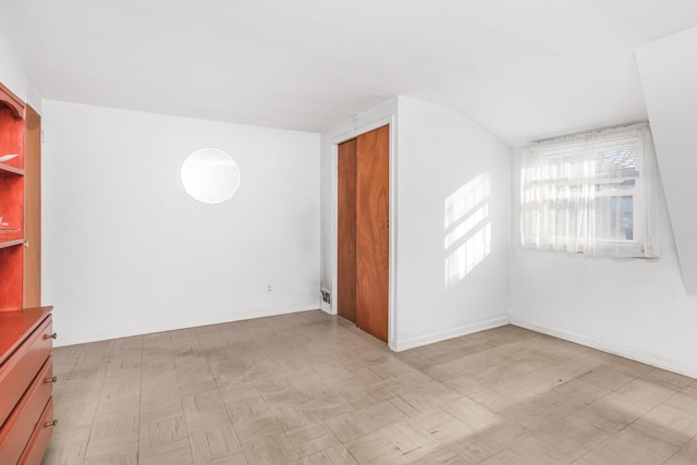 unfurnished room with baseboards