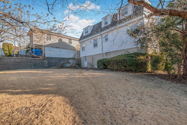 rear view of house featuring a lawn