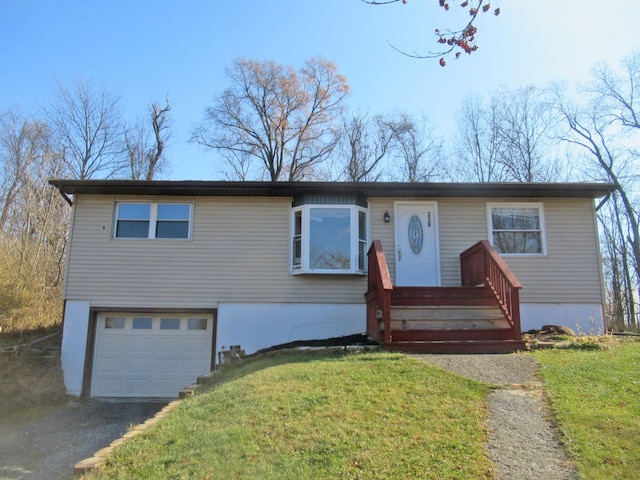 view of front of property with aphalt driveway, a front yard, and a garage