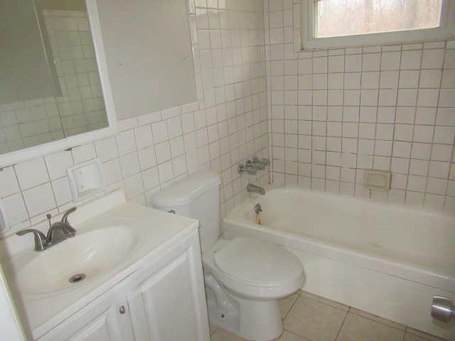 full bathroom with shower / bathing tub combination, toilet, tile walls, and tile patterned flooring