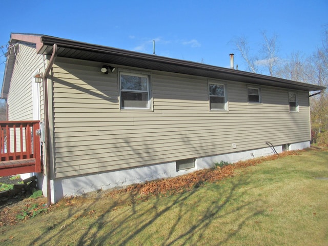 view of side of home with a yard