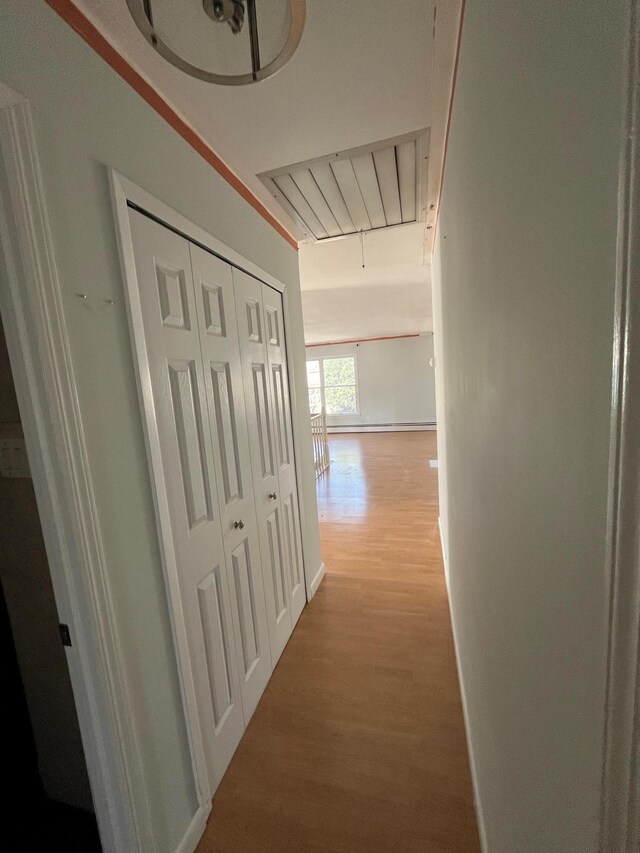 hallway with wood finished floors and baseboards