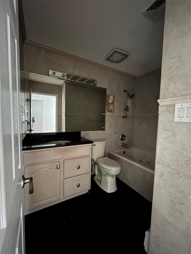 bathroom with visible vents, toilet, vanity, tile walls, and tiled shower / bath