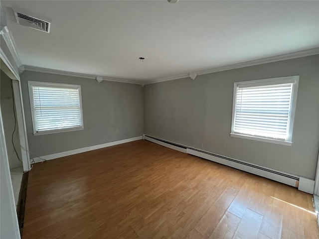 unfurnished room with ornamental molding, a healthy amount of sunlight, visible vents, and a baseboard radiator