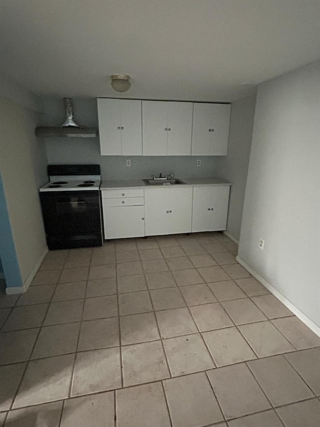 kitchen featuring a sink, white cabinets, light tile patterned floors, and electric range oven