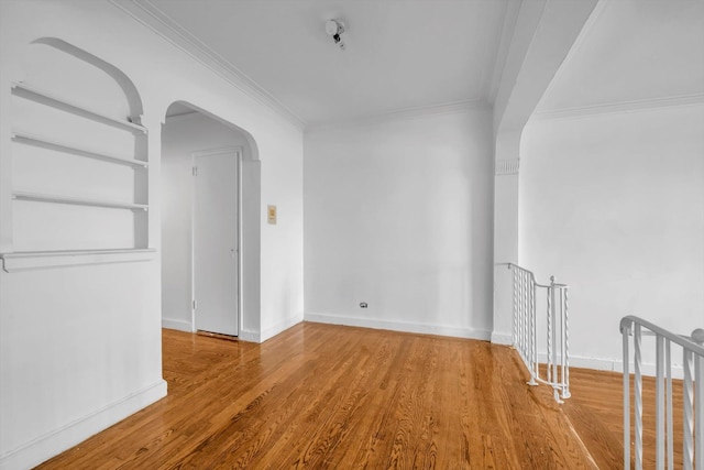 3636 Greystone Ave Unit 6M, Bronx, NY 10463 - spare room with ornamental molding, built in features, wood finished floors, arched walkways, and baseboards