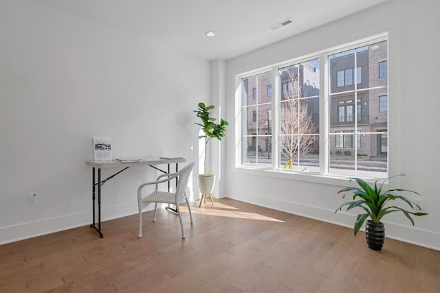 home office featuring recessed lighting, wood finished floors, visible vents, and baseboards