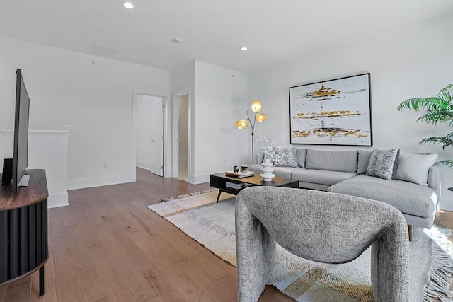 living area with recessed lighting, wood finished floors, and baseboards