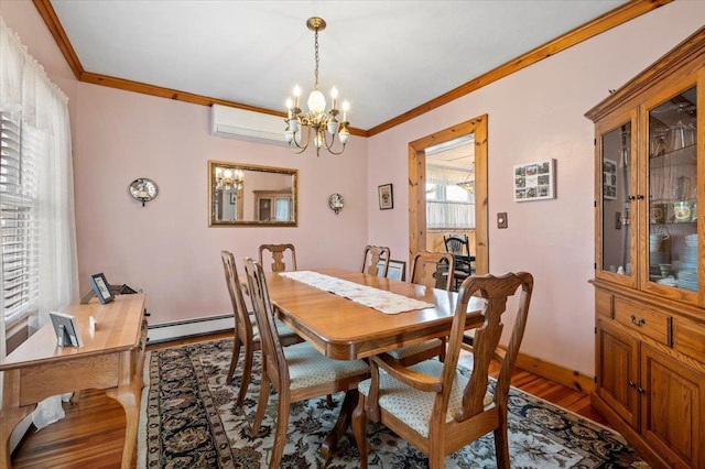 dining room featuring crown molding, a baseboard heating unit, a wall unit AC, wood finished floors, and a notable chandelier