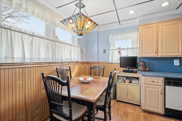 dining area featuring a wainscoted wall, ornamental molding, recessed lighting, light wood-style floors, and wooden walls