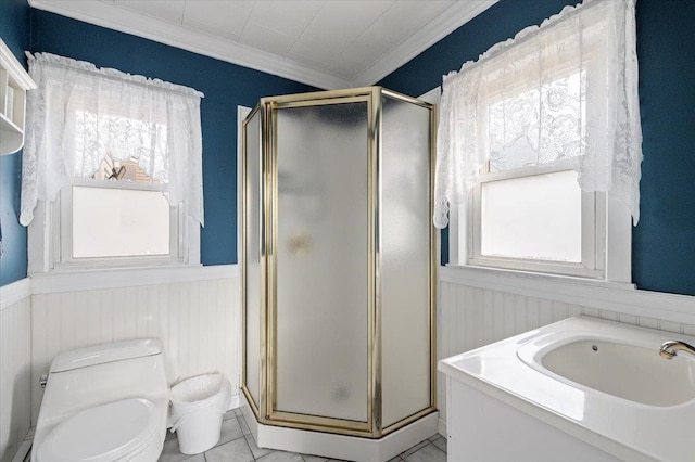 bathroom with a wainscoted wall, a shower stall, toilet, and ornamental molding