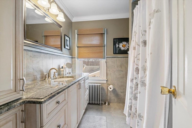 full bathroom with vanity, a wainscoted wall, radiator heating unit, crown molding, and tile walls