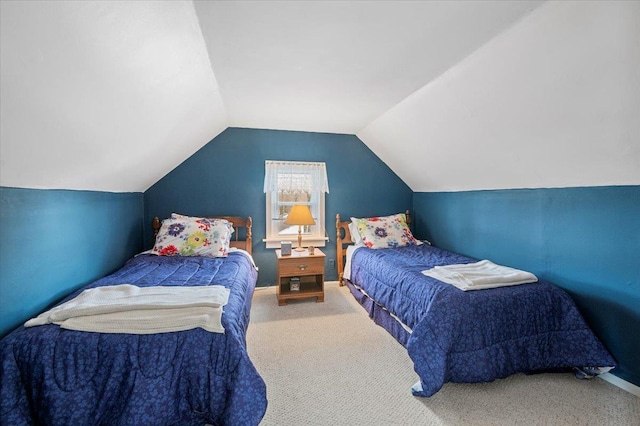 bedroom with baseboards, lofted ceiling, and carpet floors