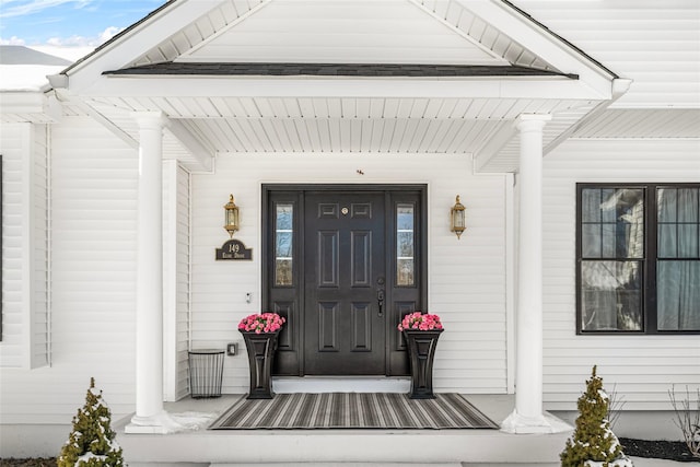 view of exterior entry with covered porch