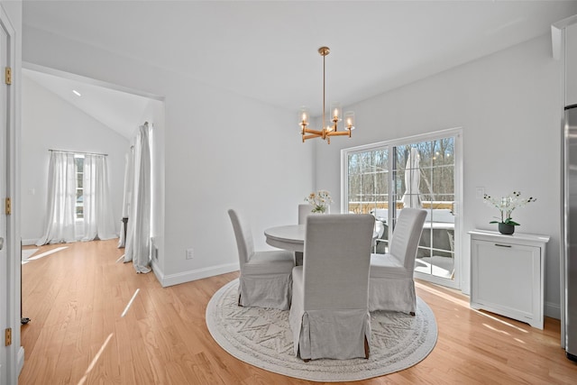 dining room with a wealth of natural light, a notable chandelier, and light wood-type flooring