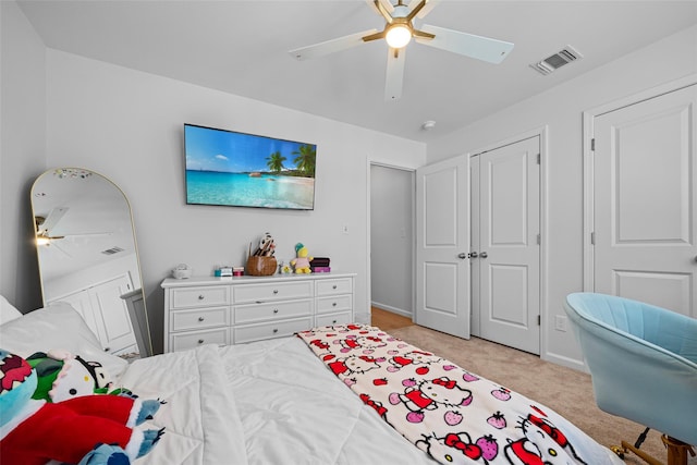 bedroom featuring visible vents, baseboards, light colored carpet, a closet, and a ceiling fan