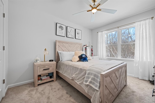 bedroom featuring baseboards, light colored carpet, and ceiling fan