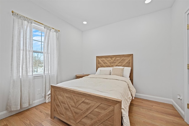 bedroom with light wood finished floors, recessed lighting, and baseboards