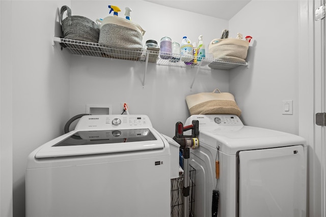 washroom with independent washer and dryer and laundry area