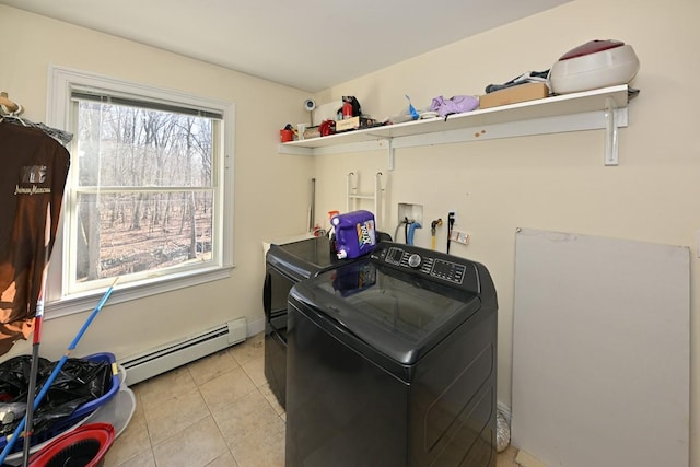 laundry area featuring light tile patterned floors, laundry area, a baseboard heating unit, and washer and dryer