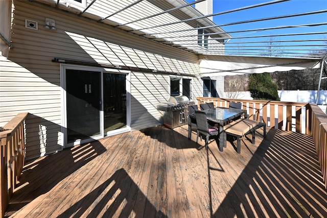 deck with outdoor dining area and a grill