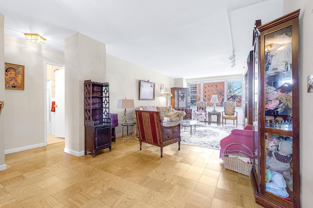 living area featuring baseboards