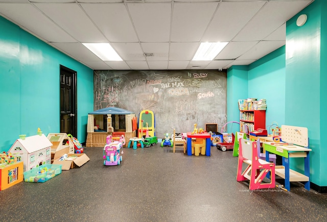 recreation room with visible vents and a paneled ceiling