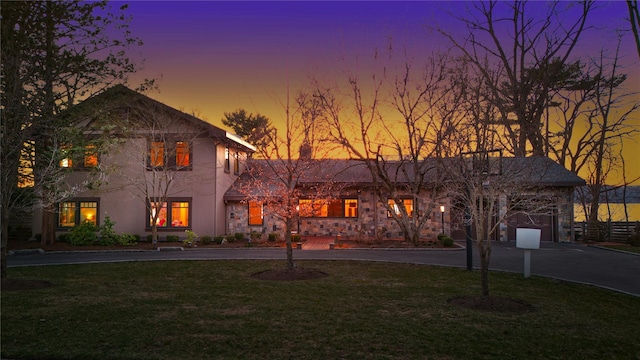 30 Half Moon Ln, Irvington, NY 10533 - view of front of property with a yard, stone siding, and curved driveway