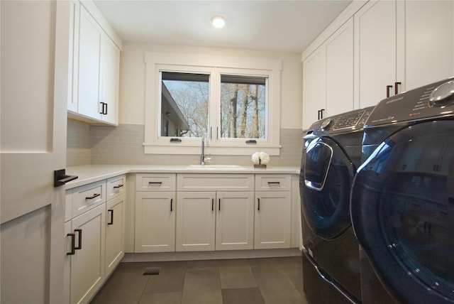 30 Half Moon Ln, Irvington, NY 10533 - laundry area featuring cabinet space, independent washer and dryer, a sink, dark tile patterned flooring, and visible vents