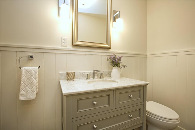30 Half Moon Ln, Irvington, NY 10533 - bathroom with a decorative wall, a wainscoted wall, toilet, and vanity