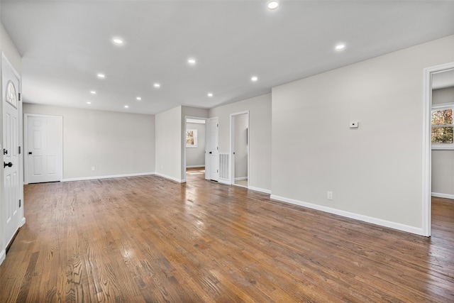 empty room with recessed lighting, baseboards, and wood finished floors